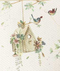 a birdhouse with flowers and birds hanging from it's roof