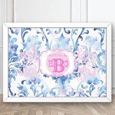 a framed photo with the letter b in pink and blue floral design on it's wall