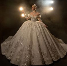 a woman in a wedding dress with lights on her head and hands behind her back