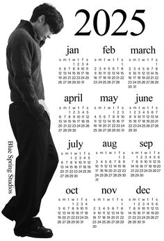 a man standing in front of a calendar