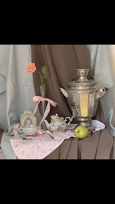 a silver tea pot sitting on top of a table