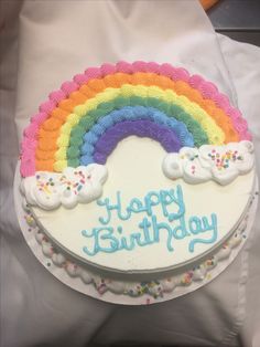 a birthday cake with rainbow frosting and sprinkles