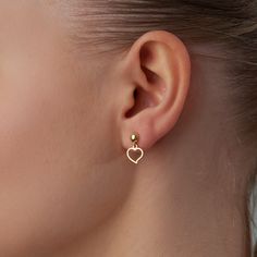 14k gold mini heart dangle earrings are a dainty and elegant way to add a touch of sparkle to your look. The tiny hearts are made of solid gold and giving them a subtle yet sophisticated look. They are lightweight and comfortable to wear, making them perfect for everyday wear. Whether you're dressing up for a night out or just running errands, these earrings will add a touch of luxury to your outfit. Tiny Heart Earrings are also a thoughtful and meaningful gift for a loved one. The heart shape i Cheap Minimalist Gold Heart Earrings, Heart Shape Earrings Gold, Minimalist Gold Heart Earrings With Charm, Dainty Heart Charm Earrings For Everyday, Dainty 14k Gold Filled Heart Earrings For Everyday, Dainty 14k Gold-filled Earrings With Heart Charm, Minimalist Yellow Gold Heart Drop Earrings, Dainty Heart Earrings With Heart Charm, Dainty Hypoallergenic Heart Drop Earrings