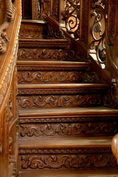 an old wooden staircase with intricate carvings on it