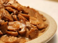 a white plate topped with meat covered in gravy