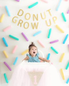 a baby in a high chair surrounded by sprinkles