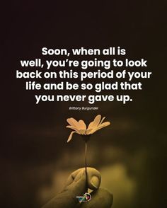 someone holding a flower in their hand that says, soon, when all is well, you're going to look back on this period of your life and be so glad that you never give up