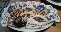 some baltimore ravens cookies are on a plate