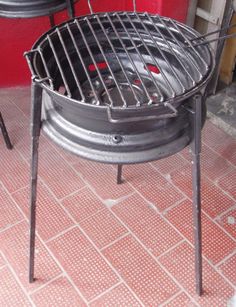 an outdoor bbq grill sitting on top of a red tile floor