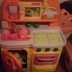 a toy kitchen with an oven, stove and other toys in it's display case