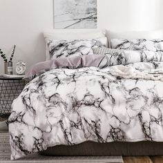 a white and black marbled comforter on a bed