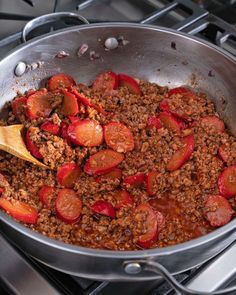 a pan filled with meat and vegetables cooking on the stove