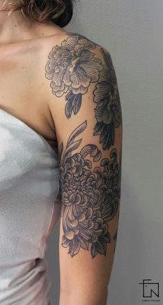 a woman's arm with flowers on it