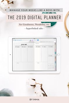 the 2019 digital planner is displayed on an ipad next to cotton flowers and other items