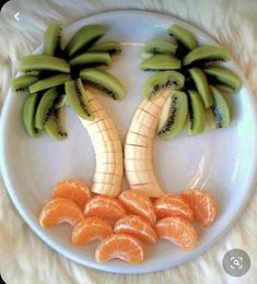 a white plate topped with sliced oranges and banana's on top of each other