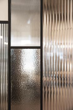 a close up of a glass window with metal bars on the outside and inside it