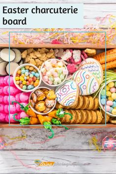 a wooden box filled with lots of different types of cookies and candies on top of a table