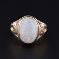 This antique ring (circa 1900) features a white opal set in 14k gold. The face of the ring measures 0.6 inches by 0.45 inches wide and is in good condition with some crazing to the opal.  The ring is a size 5.5, but it can be resized free of charge. We have many other fantastic offerings of period fine and costume jewelry posted on our Etsy store, so please consider browsing our other items. We send all items in individually packaged gift boxes. + Trademark Antiques Shop Homepage https://www.ets Vintage Opal Rings In Yellow Gold, Classic Yellow Gold Opal Ring, Vintage 14k Gold Cabochon Opal Ring, Antique Opal Rings For Collectors, Antique Opal Rings Collectible, Antique Opal Rings For Collectible, Antique 14k Gold Opal Ring, Oval Cabochon, Classic Cabochon Opal Ring, Classic Oval Cabochon Opal Ring For Formal Occasions