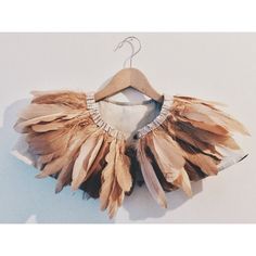 a dress made out of feathers on a hanger