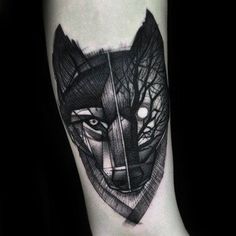 a black and white tattoo on the arm of a person with a wolf head in it