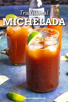 two glasses filled with iced drinks sitting on top of a blue table next to limes