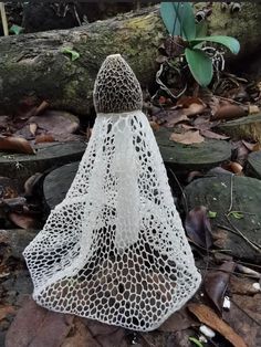 a white netted object sitting on top of rocks