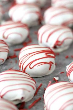 white and red candy covered cookies on a tray