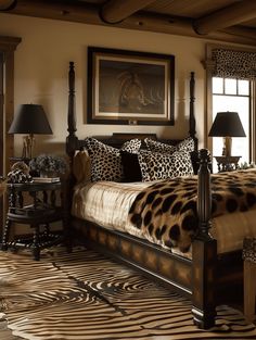 a leopard print bed in a bedroom with zebra rugs on the floor and two lamps