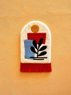 a small patch with a potted plant on it and a red fringe around the edge