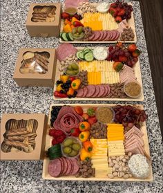 two wooden trays filled with different types of cheese and crackers next to each other