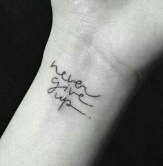 a small wrist tattoo with the word love on it