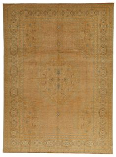 an antique rug with gold and green colors