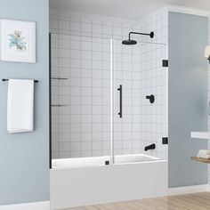 a bathroom with blue walls and white tile on the floor, along with a walk in shower