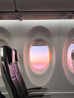 an airplane with two seats facing the window and another seat sitting in front of it