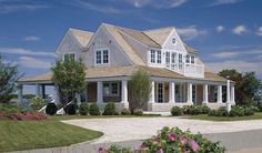 a large white house sitting on top of a lush green field