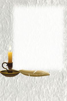 a candle is lit next to a feather on a plate