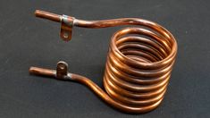 a close up of a coil on a black surface