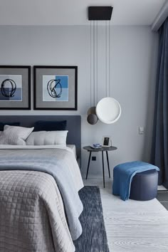 a bedroom with blue and white decor in shades of gray, light grey and dark blue