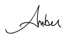 an autographed image of the name amba in cursive writing on a white background