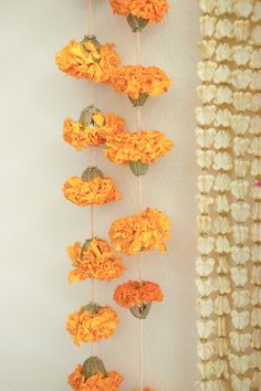 orange flowers are hanging on the wall