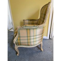 a chair sitting in front of a yellow wall next to a white door and carpeted floor