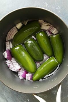 some green peppers and onions in a pot