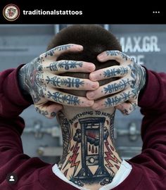 a man with tattoos covering his face and hands