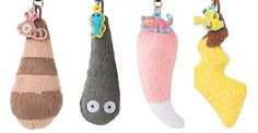 three different colored stuffed animals hanging from hooks