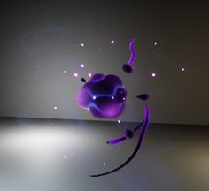 a purple object floating in the air on top of a white floor next to a wall