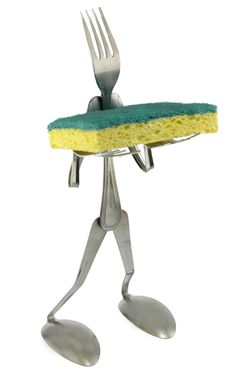 a person holding a fork and sponge on top of a metal holder with two forks