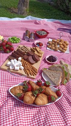 a picnic table covered in food and snacks