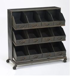 an old metal drawer with many drawers on it's sides and wheels, holding several bins