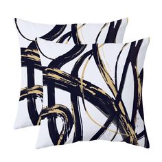 two pillows with black and gold designs on them