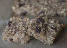 two granola bars sitting on top of a piece of parchment paper